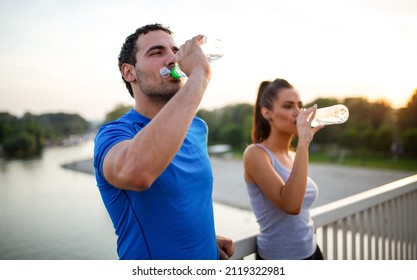 Portrait of happy fit sporty couple relaxing after a running outdoors. - Powered by Shutterstock