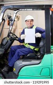 Portrait Of Happy Forklift Driver Displaying Blank Placard