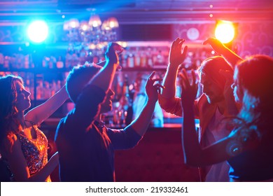 Portrait of happy friends dancing at party - Powered by Shutterstock