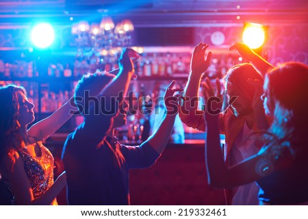 Portrait of happy friends dancing at party