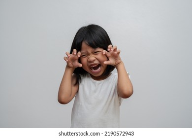 Portrait Of Happy And Funny Asian Child Girl On White Background, A Child Looking At Camera. Preschool Kid Dreaming Fill With Energy Feeling Healthy And Good Concept