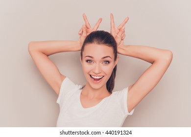 Portrait Of Happy Funny Girl Showing Bunny Ears With Fingers