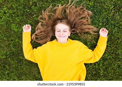 Portrait of a happy  girl laying  on the grass, smile and looking at camera.  - Powered by Shutterstock