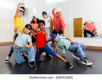 Portrait Of Happy Girls And Boys Hip Hop Dancers And Woman Instructor Posing During Group Dance Workout