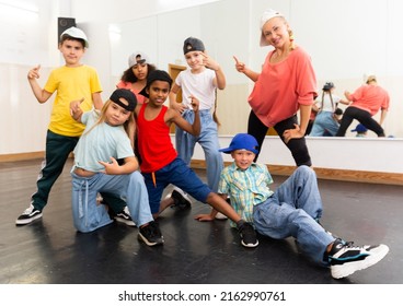 Portrait Of Happy Girls And Boys Hip Hop Dancers And Woman Instructor Posing During Group Dance Workout