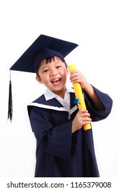 Portrait Of Happy Graduate Little Asian Boy Student Holding A Certificate With Graduation Gown And Hat, Isolated On White Background. Child Back To School And Educational Concept.