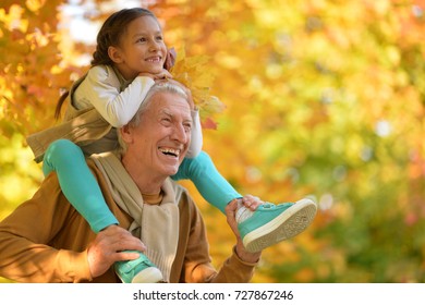 portrait of happy grandfather and granddaughter