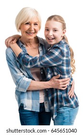 Portrait Of Happy Grandmother And Granddaughter Embracing Isolated On White In Studio  