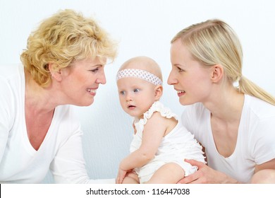 Portrait Of Happy Grandmother, Mother And Cute Baby Girl