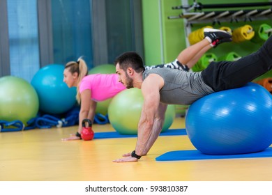 Portrait of happy group exercising on Swiss ball