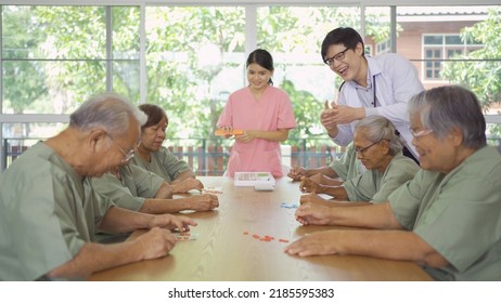 Portrait Of Happy Group Of Old Elderly Asian Patient Or Pensioner People With A Nurse And Doctor Playing Games In Nursing Home. Senior Lifestyle Activity Recreation. Retirement Community. Health Care