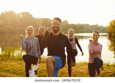 Portrait of a happy group of people exercising and doing sports and workout in a city park. Outdoor fitness activities, highlighting the team commitment to staying active and healthy. - Powered by Shutterstock