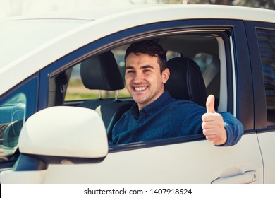 Portrait Of Happy Guy, Uber Driver Showing Thumb Up Positive Gesture, Smiling Gently To Camera. Cheerful Man Driving His New Car, Excellent Acquisition Feedback, Customer Satisfied With Purchase.