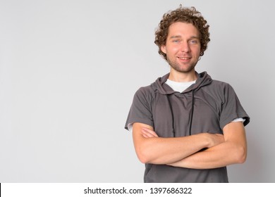 Portrait of happy handsome man smiling with arms crossed
