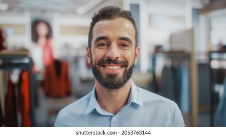 Portrait Of A Happy Handsome Store Assistant In Blue Shirt Smiling And Posing For Camera At Clothing Store. Small Business Owner In A Role Of A Businessman Or Sales Manager.