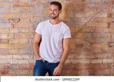 Portrait Of A Happy Handsome Young Man In A White Tshirt.