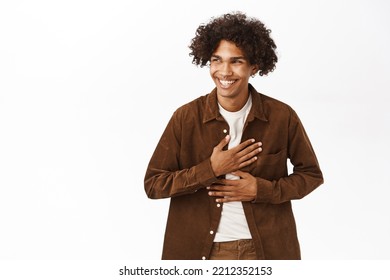 Portrait Of Happy Hispanic Young Man, 20 Years Old, Laughing And Smiling, Genuine Happiness, Standing Over White Background