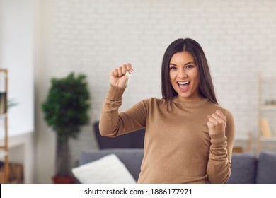 Portrait Of Happy Homeowner Showing Keys To New Home. Excited Single Young Woman Celebrating Buying Her Own House Or Apartment. Real Estate, Mortgage, Purchase Of Property And Moving Day Concept