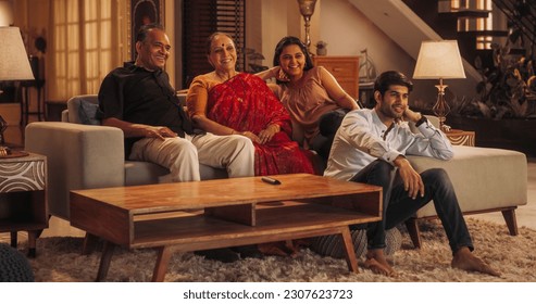 Portrait of Happy Indian Family Enjoying Movie Playing on TV at Home Together. Parents and Young Adult Children Share Love for Cinema, watching Favourite Streaming Service TV Shows - Powered by Shutterstock