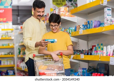 Portrait of happy indian father and son with purchases during family shopping in supermarket - Powered by Shutterstock