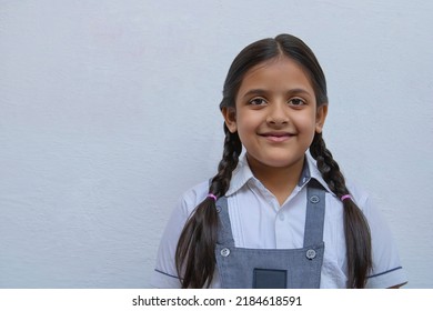 Portrait of a happy Indian school girl with ponytails