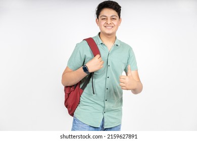 Portrait of happy indian teenager college or school boy with backpack do thumbs up, isolated on white background. Smiling young asian male kid looking at camera. - Powered by Shutterstock