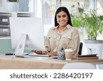 Portrait, happy or Indian woman at a desk typing an email, planning schedule or company goals. Administration, smile or computer of proud Human Resources manager, corporate person or worker in office