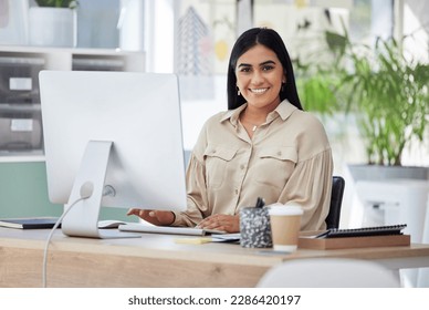 Portrait, happy or Indian woman at a desk typing an email, planning schedule or company goals. Administration, smile or computer of proud Human Resources manager, corporate person or worker in office