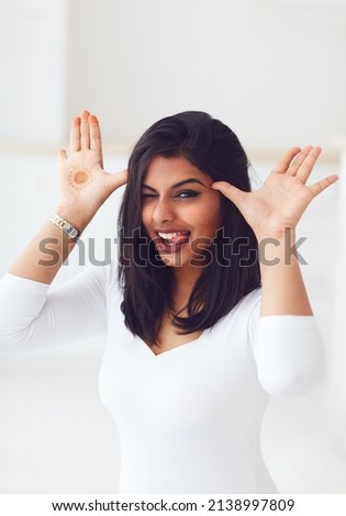 portrait of happy indian woman having fun at home. playing a fool, mischievous behavior