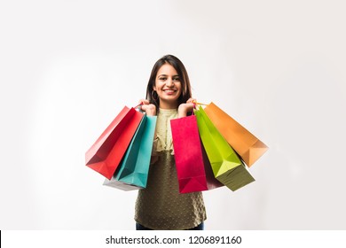 Portrait Of A Happy Indian Woman Or Young Girl Carrying Shopping Bags, Isolated Over White Background
