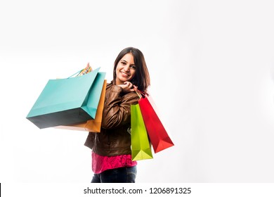 Portrait Of A Happy Indian Woman Or Young Girl Carrying Shopping Bags, Isolated Over White Background
