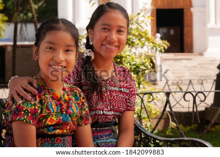 
Portrait of happy indigenous girls smiling, looking at camera.