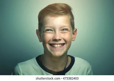 Portrait Of Happy Joyful Beautiful Happy Teenage Boy With Stylish Haircut And Bright Eyes, Softbox Lighting Studio Shot.