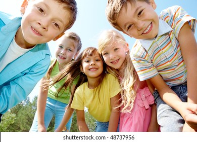 Portrait Of Happy Kids Outdoor Looking At Camera