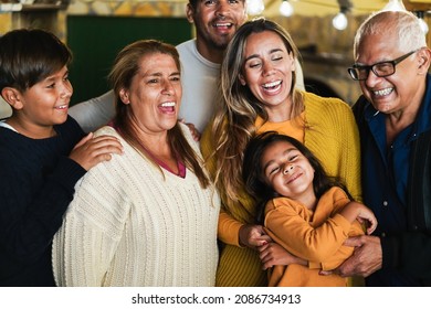 Portrait Of Happy Latin Family Smiling On Camera At Home - Focus On Grandmother Face