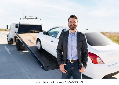 Portrait Of A Happy Latin Guy Smiling Because The Tow Truck Service Came To Get His Broken-down Car From The Side Of The Road