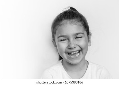 Portrait Of A Happy Laughing Child Girl. Black And White Image.