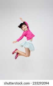 Portrait Of Happy Little Asian Child Jumping