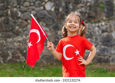 Portrait of happy little kid. Cute baby with Turkish flag t-shirt. Toddler hold Turkish flag in hand. Patriotic holiday. Adorable child celebrates national holidays. Copy space for text. - Shutterstock ID 1921132274