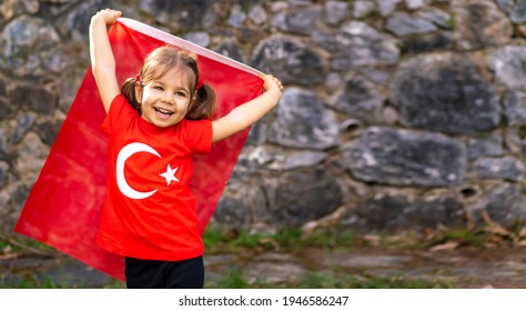 Portrait Of Happy Little Kid. Cute Baby With Turkish Flag T-shirt. Toddler Hold Turkish Flag In Hand. Patriotic Holiday. Adorable Child Celebrates National Holidays. Copy Space For Text.