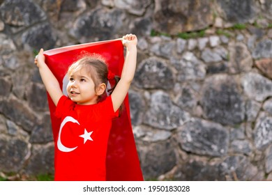 Portrait Of Happy Little Kid. Cute Baby With Turkish Flag T-shirt. Toddler Hold Turkish Flag In Hand. Copy Space For Text.