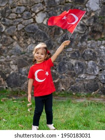 Portrait Of Happy Little Kid. Cute Baby With Turkish Flag T-shirt. Toddler Hold Turkish Flag In Hand. Copy Space For Text.