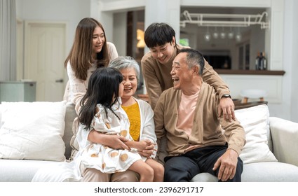 Portrait of happy love family asian father and mother playing with adorable asian kid girl.daughter, care, insurance.Happy family moments good time love with grandparents.Love of big family - Powered by Shutterstock