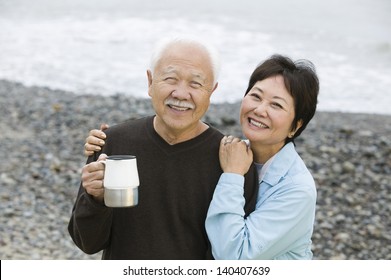 Portrait of a happy and loving mature couple at the beach - Powered by Shutterstock