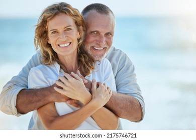Portrait of happy and loving retired mature caucasian couple enjoying a romantic date at the beach on a sunny day. Cheerful affectionate husband hugging his wife while enjoying seaside vacation - Shutterstock ID 2175746721