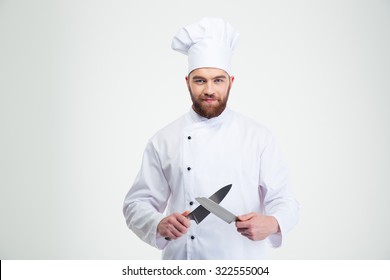 Portrait Of A Happy Male Chef Cook Sharpening Knife Isolated On A White Background