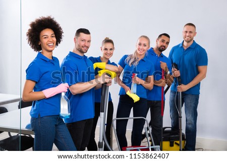 Portrait Of Happy Male And Female Janitors With Cleaning Equipment Foto d'archivio © 