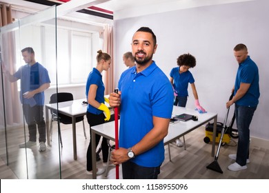 Portrait Of A Happy Male Janitor In Office