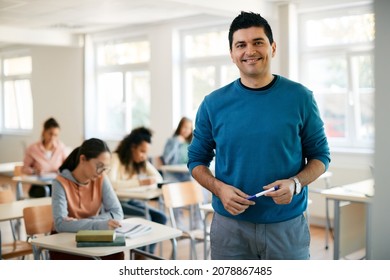 Portrait Of Happy Male Professor During A Class At High School Looking At Camera.