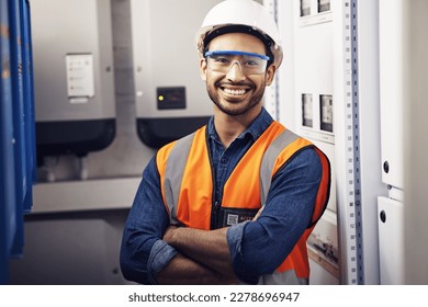 Portrait, happy man and engineering technician in control room, inspection service or industry maintenance. Electrician, arms crossed and smile in electrical substation, system or industrial mechanic